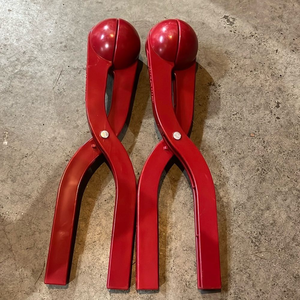 Two snow Ballers great for snowball fights from Brookstone red